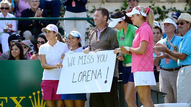 Commissioner Whan and several players hold a We Miss You Lorena sign