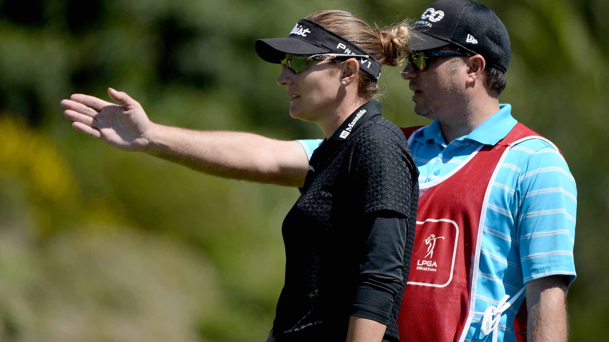 Brittany Lang lines up putt on the 18th hole with caddie during Round One of the KIA Classic 