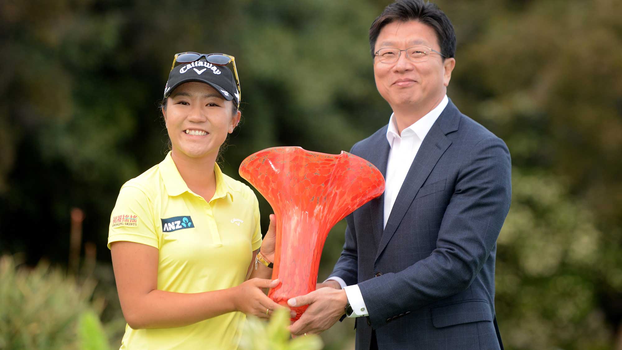 Lydia Ko of New Zealand holds the winners trophy with President and CEO of North American KIA Jang Won Sohn after her -19 under victory during the final round of the KIA Classic