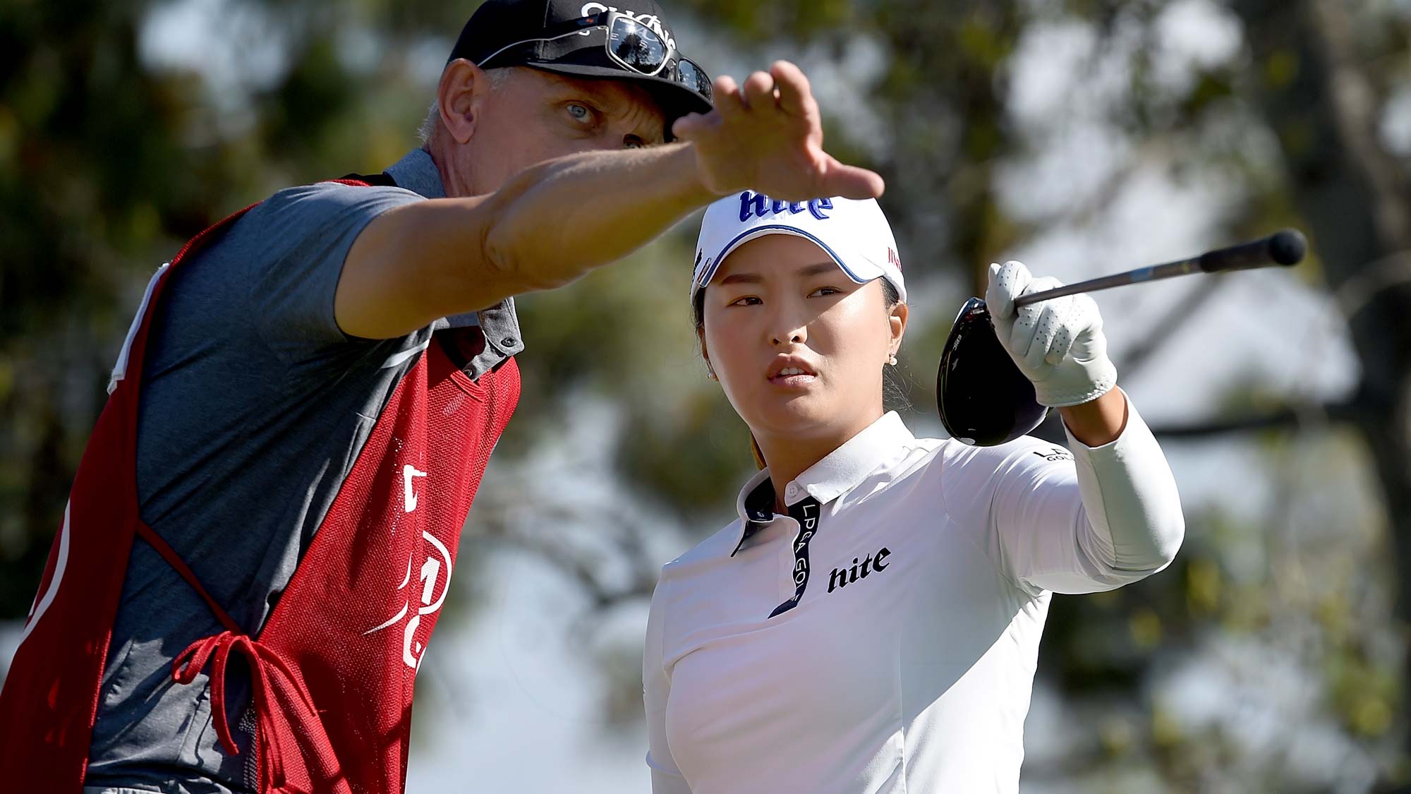 Jin Young Ko of Korea speaks with her caddie on the 16th hole tee box during the first round of the Kia Classic