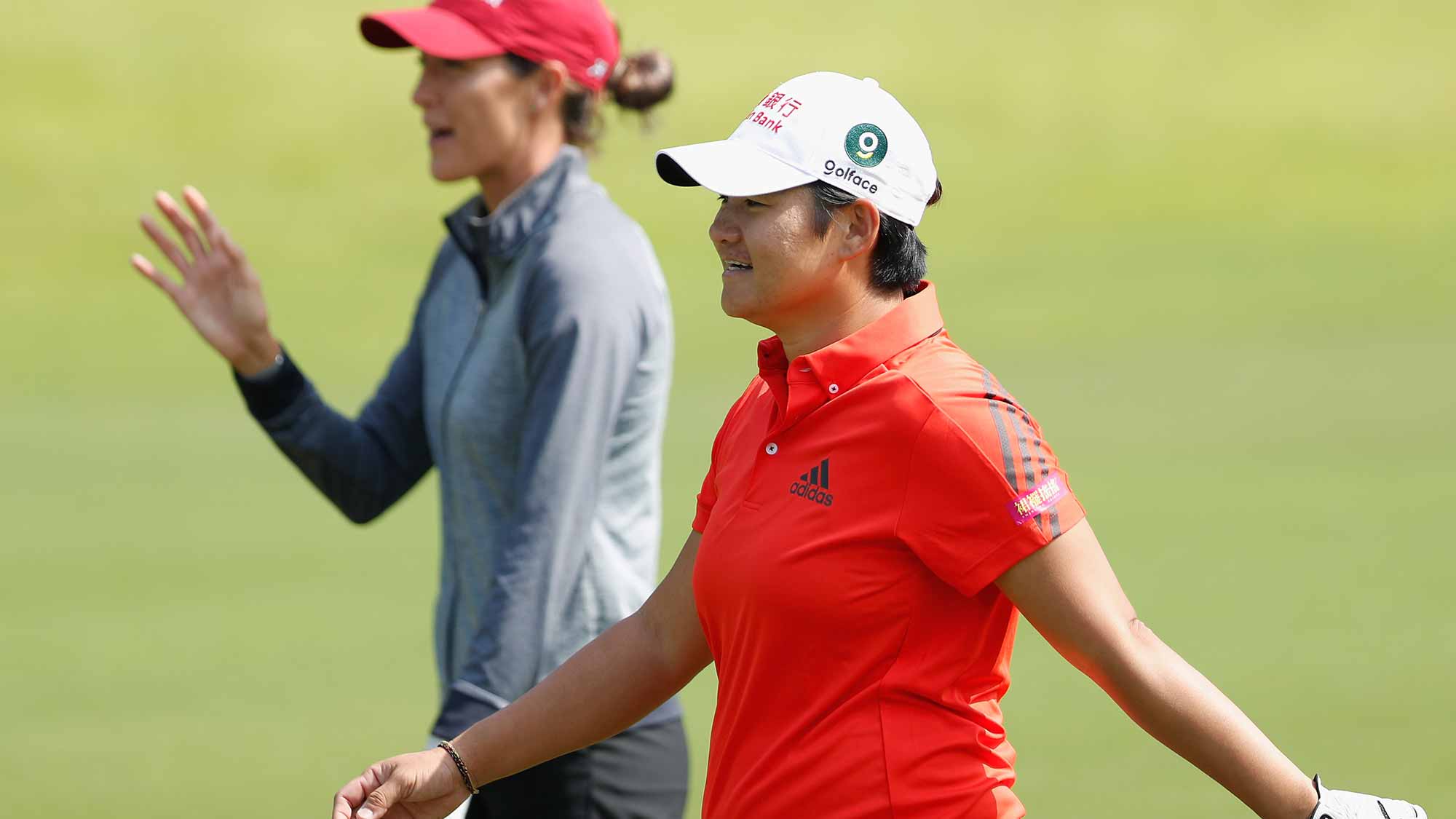 Jaye Marie Green of the United States and Yani Tseng of Chinese Taipei chat on the course during the third round of the Swinging Skirts LPGA Taiwan Championship at Ta Shee Golf & Country Club on October 27, 2018 in Taoyuan, Chinese Taipei
